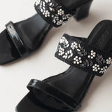 gleaming Black Embroidered Block Heels in white background close up shot