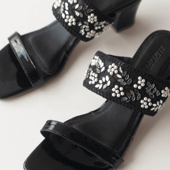 gleaming Black Embroidered Block Heels in white background close up shot