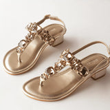 radiant gold rhinestone block heels in white background