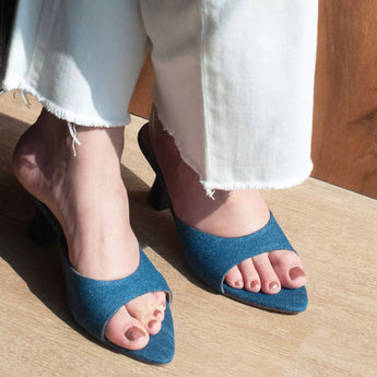 woman wearing denim pointed toe kitten heels